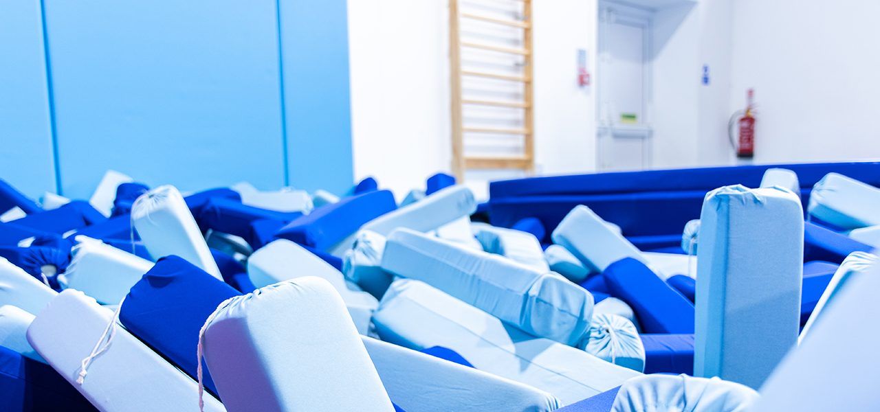 Blue and pale blue foam blocks in a gymnastics pit