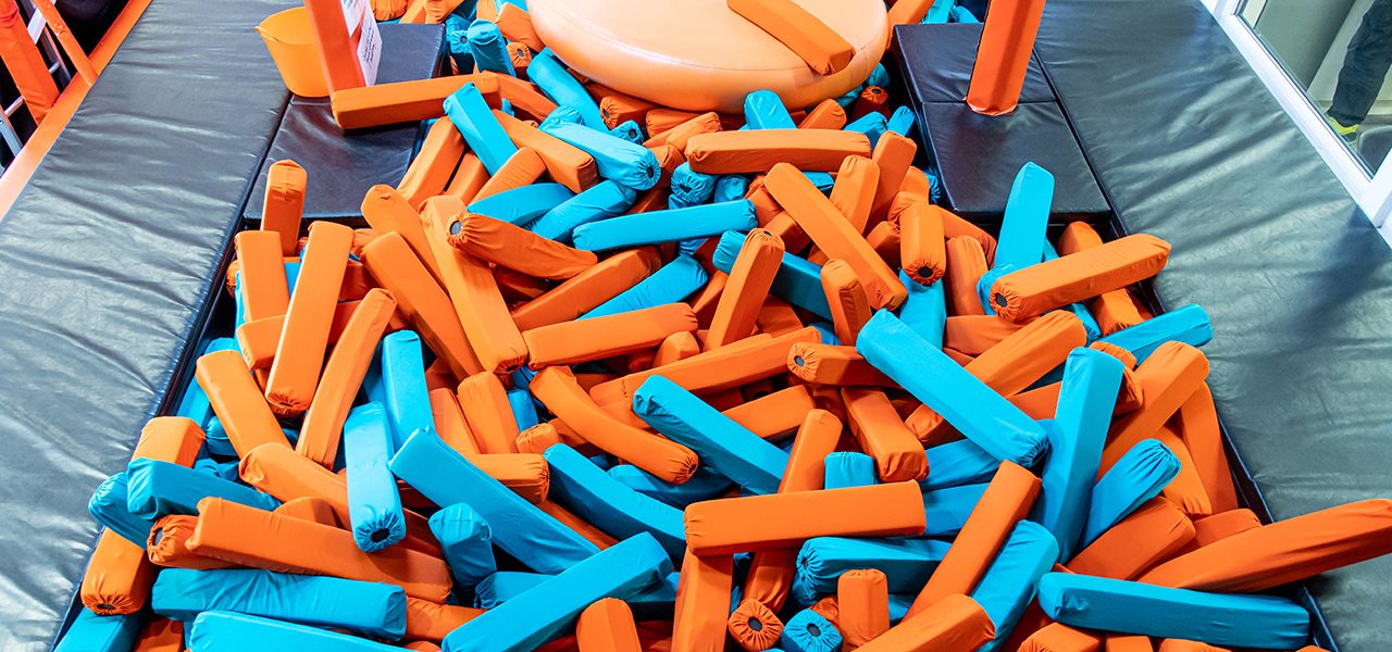 Orange and turquoise covered foam blocks in a pit