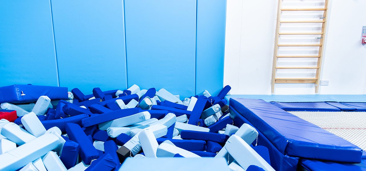 Blue foam pit with surrounding blue matting