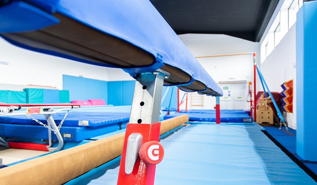 Blue padding beneath gymnastics equipment