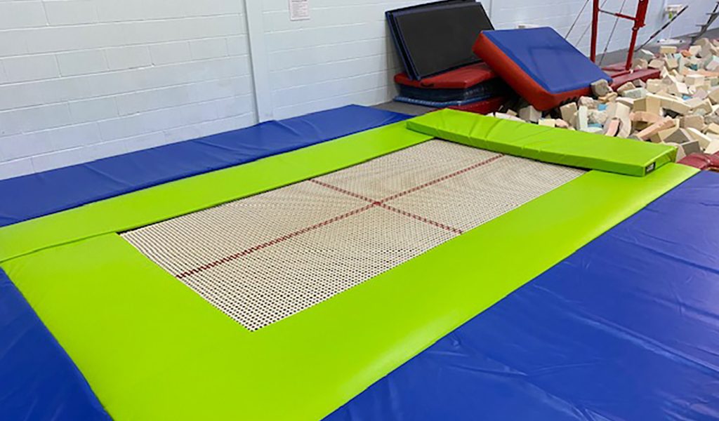 Green surround padding around a recessed trampoline