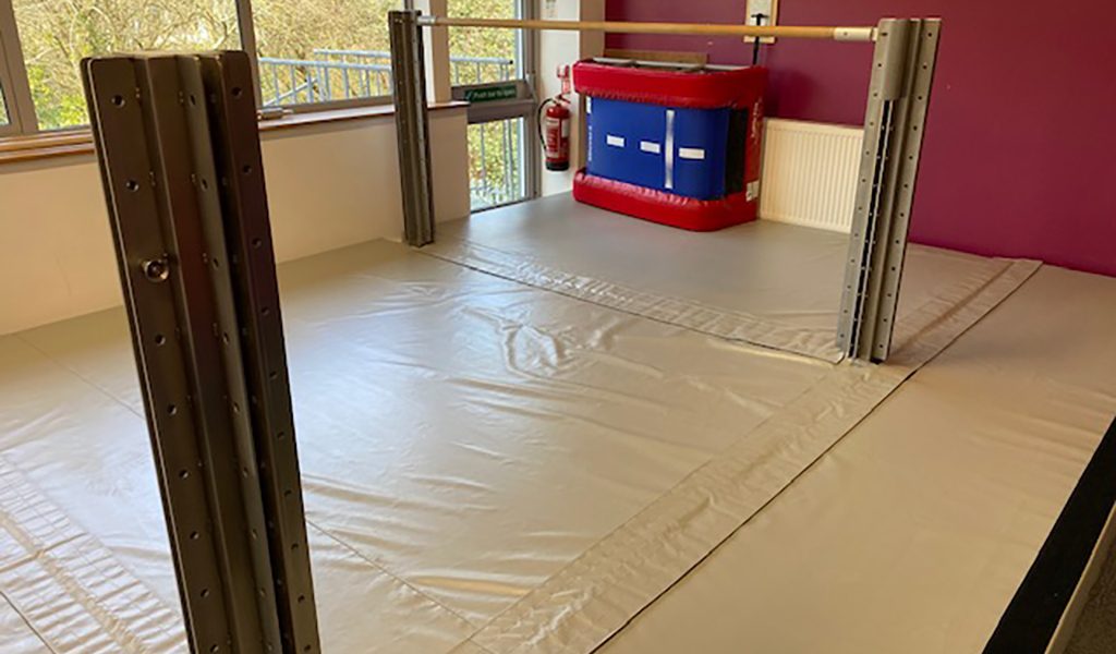 Cream protective matting around indoor supports