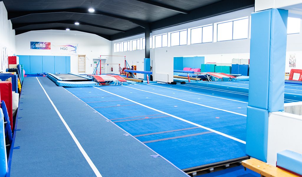 Blue matted training floor in a gymnastics facility